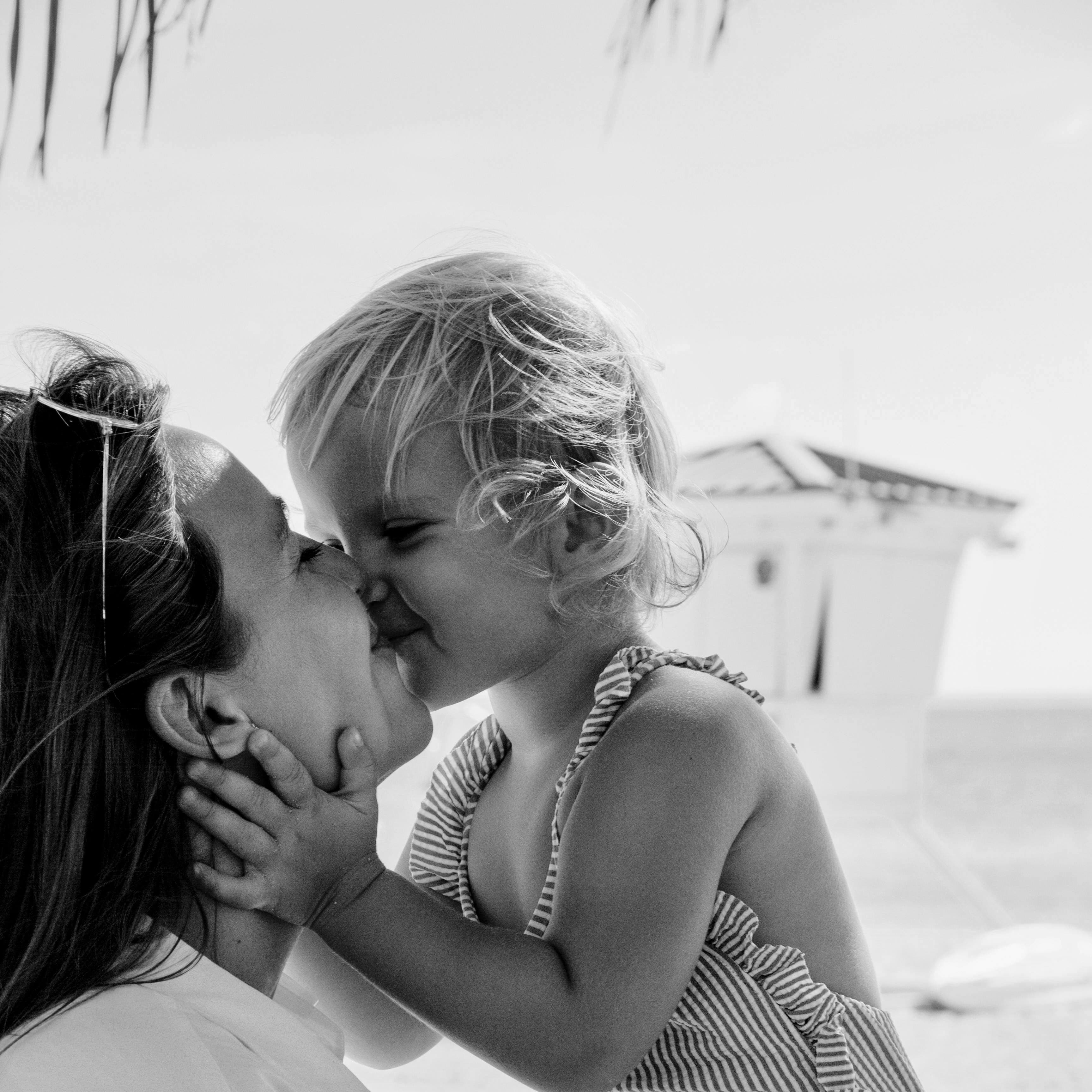 Parent and child sharing a kiss